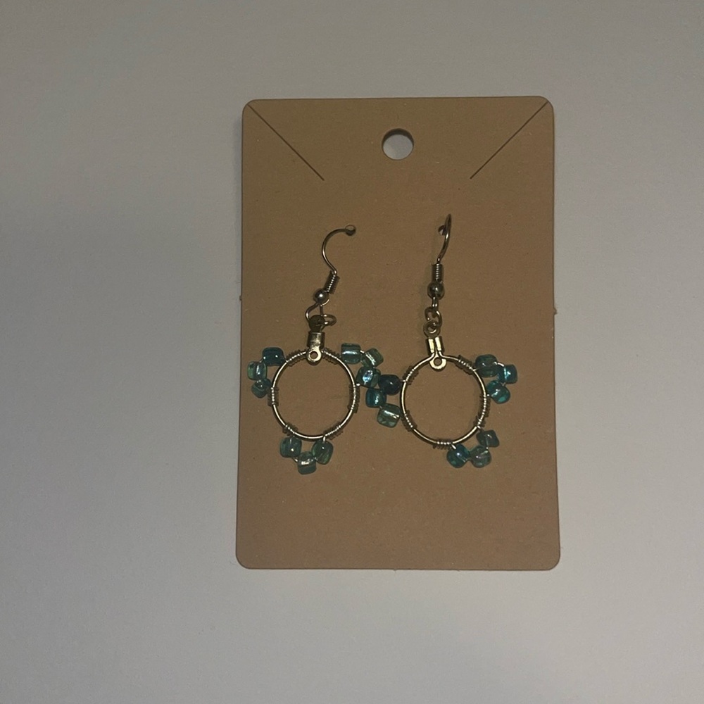 Dangly circle handmade earrings with blue beads.